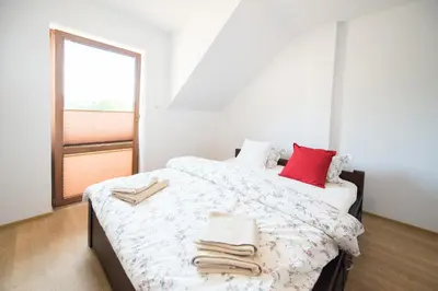 a bedroom with a bed with towels on it at u Jagody in Mszana Dolna