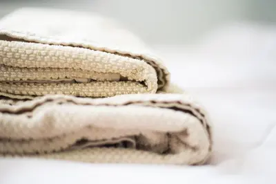 a pile of white towels sitting on a table at u Jagody in Mszana Dolna