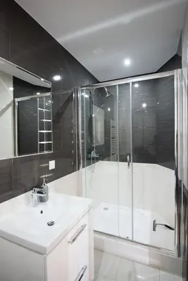 a bathroom with a shower and a sink and a tub at u Jagody in Mszana Dolna