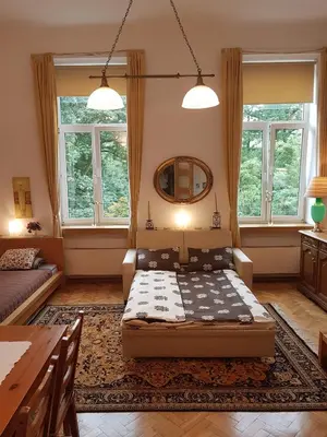 a bedroom with a bed in a room with windows at Leonardo in Kraków