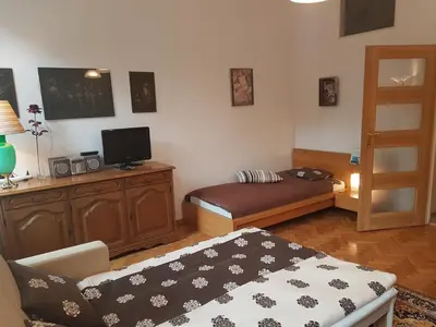 a small living room with a bed and a couch at Leonardo in Kraków