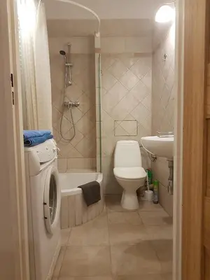 a bathroom with a shower toilet and a sink at Leonardo in Kraków