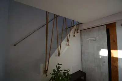a staircase in a room with a potted plant at LendHouse - SPA pod Gwiazdami in Sąspów