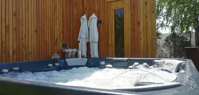 a bath tub filled with snow in front of a house at LendHouse - SPA pod Gwiazdami in Sąspów
