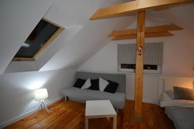 a living room with a couch and a tv at LendHouse - SPA pod Gwiazdami in Sąspów
