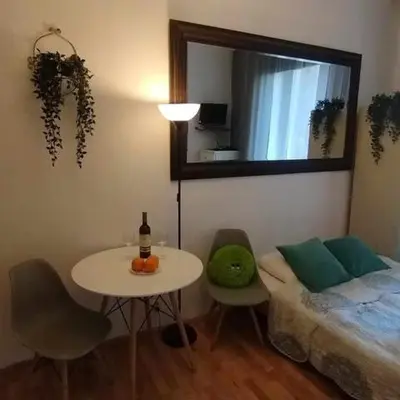 a room with a table and a bed and a mirror at Your trip apartment (2) in Kraków