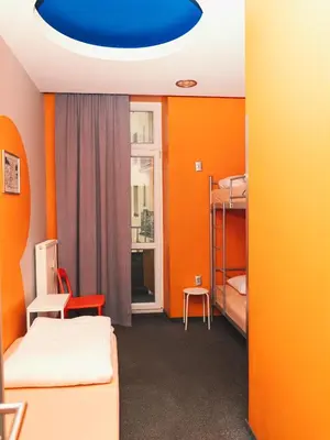 a room with two bunk beds and a blue ceiling at LazeMaze Hostel in Kraków