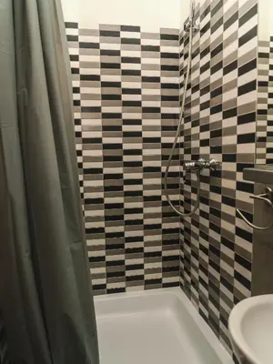 a bathroom with a shower and a sink at LazeMaze Hostel in Kraków
