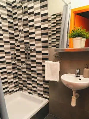a bathroom with a shower and a sink at LazeMaze Hostel in Kraków