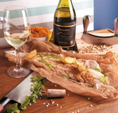 a sandwich on a table with a bottle of wine and a glass at Dwór Sieraków in Sieraków