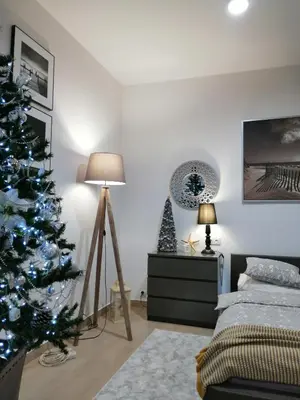 a bedroom with a christmas tree and a bed at Apartament Rondo in Trzebinia