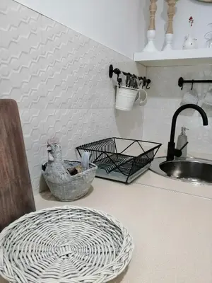 a kitchen counter with a sink and a chicken bowl at Apartament Rondo in Trzebinia