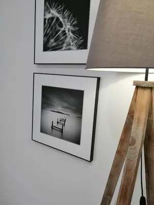 a picture of a bench on a wall with pictures at Apartament Rondo in Trzebinia