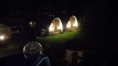 a house with lights on the front of it at night at Zajazd pod Chmurką in Rabka