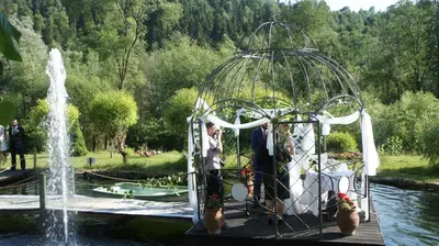 a group of people standing next to a fountain at Zajazd pod Chmurką in Rabka