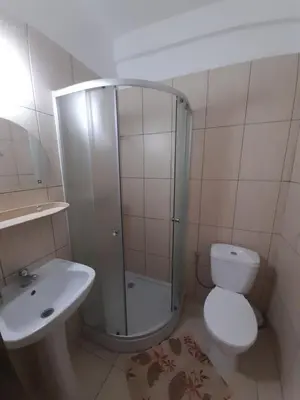 a bathroom with a shower and a toilet and a sink at Green Hostel in Kraków