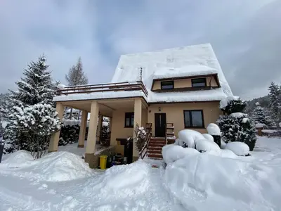 a snow covered house with a pile of snow at Dom do wynajęcia 