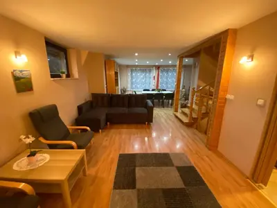 a living room with a couch and a table at Dom do wynajęcia 