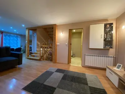 a living room with a couch and a stair case at Dom do wynajęcia 
