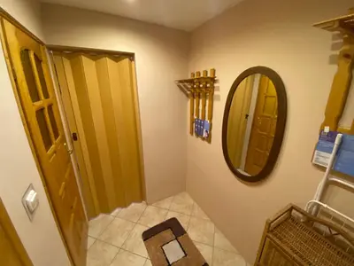 a bathroom with a mirror next to a door at Dom do wynajęcia 