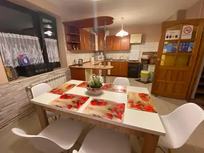 a kitchen with a table and chairs in a kitchen at Dom do wynajęcia 