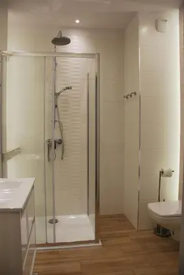 a bathroom with a shower and a sink at Margaret Apartments in Kraków