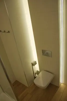 a white toilet in a bathroom with a shower at Margaret Apartments in Kraków