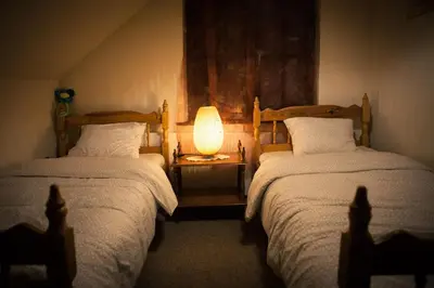 a bedroom with two beds and a lamp on a table at KrakowHouse in Libertów