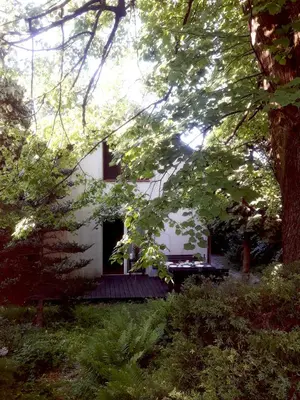 a white house with a window and trees at KrakowHouse in Libertów
