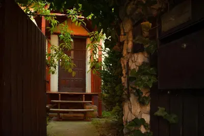a house with a bench in front of a door at KrakowHouse in Libertów