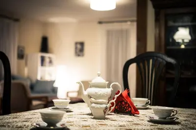 a table with a tea pot and two cups on it at KrakowHouse in Libertów