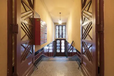 an empty hallway with two doors and a window at Apartment for guests (1) in Kraków