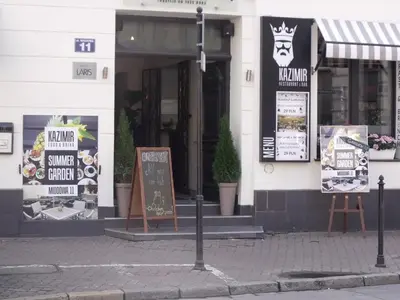 a building with signs outside of it on a street at Apartment for guests (1) in Kraków