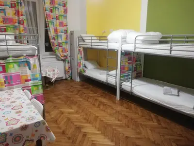 a room with two bunk beds and a wooden floor at Lorf Hostel&Apartments in Kraków