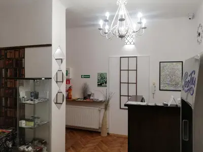 a living room with a chandelier and a desk at Lorf Hostel&Apartments in Kraków