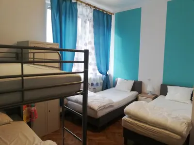 two bunk beds in a room with blue walls at Lorf Hostel&Apartments in Kraków