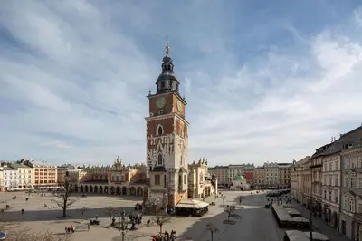 a clock tower in the middle of a city at Jana 3 Apartments in Kraków