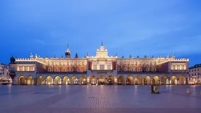 a large building in a square at night at Jana 3 Apartments in Kraków