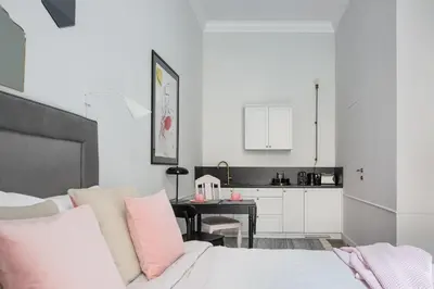 a living room with a bed and a kitchen at Jana 3 Apartments in Kraków