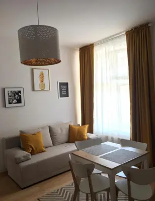 a living room with a couch and a table at Jana 3 Apartments in Kraków