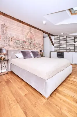 a bedroom with a large bed and a brick wall at Chodkiewicza 10 (A) - cozy studio by Homeprime in Kraków