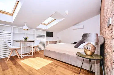 a bedroom with a bed and a desk and a table at Chodkiewicza 10 (A) - cozy studio by Homeprime in Kraków