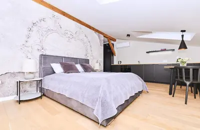 a bedroom with a large bed and a table at Chodkiewicza 10 (B) - cozy studio by Homeprime in Kraków