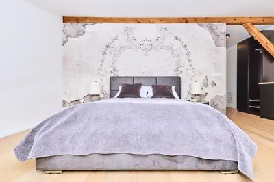 a bedroom with a bed with a gray blanket at Chodkiewicza 10 (B) - cozy studio by Homeprime in Kraków