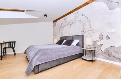 a bedroom with a large bed with a map on the wall at Chodkiewicza 10 (B) - cozy studio by Homeprime in Kraków