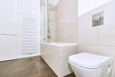 a white bathroom with a toilet and a shower at Chodkiewicza 10 (B) - cozy studio by Homeprime in Kraków