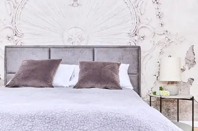 a bedroom with a white bed with a large headboard at Chodkiewicza 10 (B) - cozy studio by Homeprime in Kraków