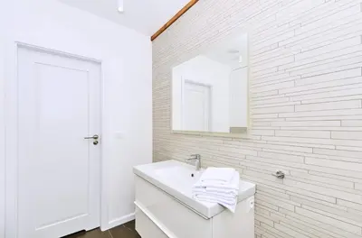 a white bathroom with a sink and a mirror at Chodkiewicza 10 (B) - cozy studio by Homeprime in Kraków
