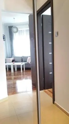 a living room with a mirror and a couch at Royals Flower Apartments III in Kraków