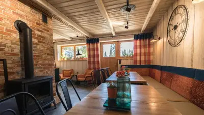 a dining room with a table and a fireplace at Góralska Willa in Nowy Targ